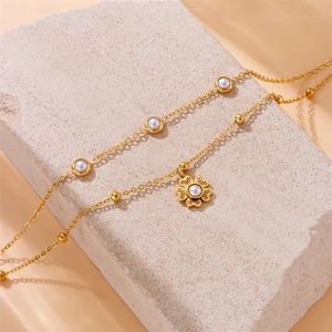 Elegant gold double-layer stainless steel anklet with pearl flower pendant on stone
