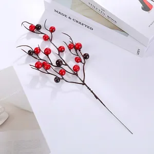 Close-up of artificial red berries on dark brown stems for festive home floral decor