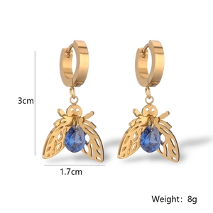 Macro detail of bee earrings featuring gold plating, blue zircon, and exact dimensions