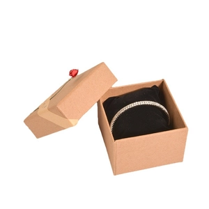 Brown kraft paper gift box with black velvet pad and silver rhinestone bracelet
