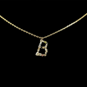 Detail of letter B necklace pendant with colorful gemstones on a gold-plated chain