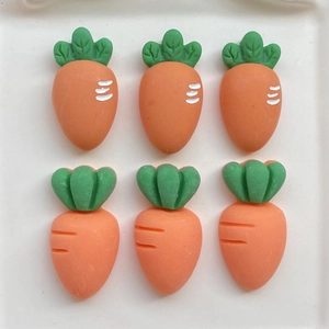 Assorted orange resin carrots with green leaves for DIY crafts and accessories