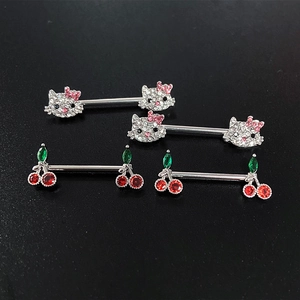 Detailed macro view of crystal-encrusted kitty and cherry body piercing jewelry studs
