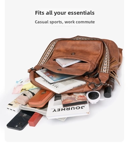 Detail showing high-capacity leather backpack with ethnic strap, tassels and daily items