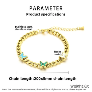 Detailed spec view of vintage butterfly chain bracelet in stainless steel with resin charms