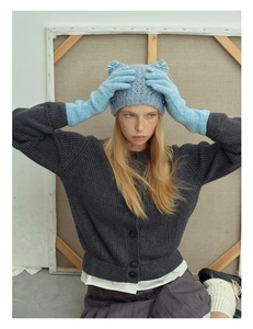 Detail of wool blend knitted long gloves and cat ear hat on a model for winter warmth