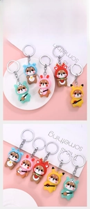 Detail showing five cartoon Shiba Inu charms featuring Pikachu and animal costumes