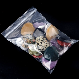 Polished heart-shaped natural crystal worry stones in a clear storage bag