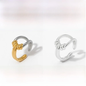 Detail view of twisted stainless steel ear cuffs in silver and gold-tone finishes