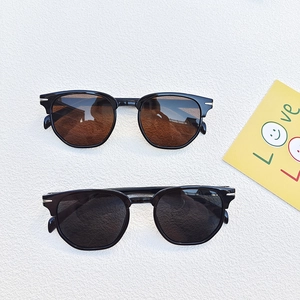 Classic thick-frame sunglasses in amber and black with silver metal temple accents