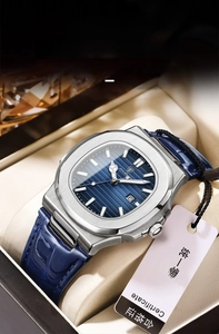 Detailed close-up of octagonal steel watch case with blue textured dial and leather strap