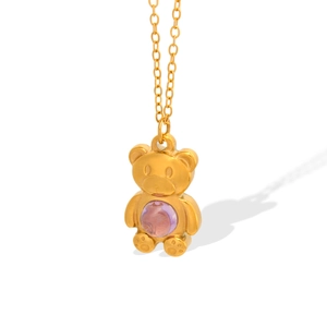 Minimalist Y2K gold-tone bear pendant necklace featuring a purple bead on white background