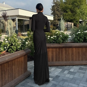 Detail of the elegant radial pleats and ruched design on back of black maxi dress