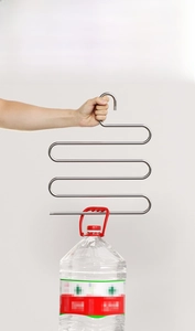 Detail of multi-tier stainless steel pants hanger demonstrating heavy load-bearing capacity