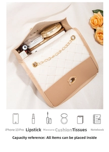 Top view of the beige quilted crossbody bag interior holding daily essentials and phone