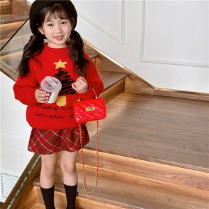 Kids quilted red crossbody bag styled with a festive red Christmas knit sweater