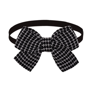 Close-up of black and white tweed pet bow tie with elegant ribbed ribbon texture