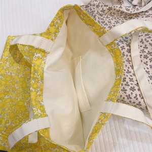 Detail shot of the yellow floral tote bag interior with a practical inner pocket