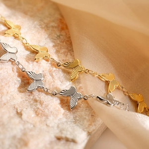 18K gold plated stainless steel butterfly bracelets in gold and silver on pink background