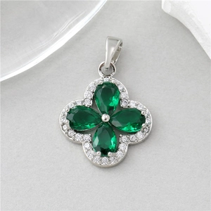 Detail of four-leaf clover pendant with green pear-shaped stones and pavé crystals