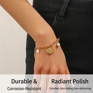 Close-up of gold plated stainless steel bracelet with sunflower, star and pearl charms