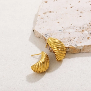 Detail of 18K gold plated hoop earrings with textured ribbed croissant design