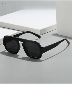 Detail showing high-gloss texture and thick frame design of black pilot sunglasses
