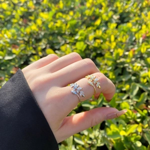 Close-up of gold and silver leaf rings with marquise zircon on a model finger