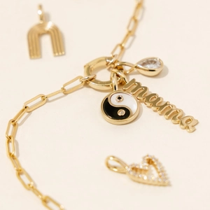 Golden paperclip chain bracelet with yin-yang mama and zircon gemstone charms