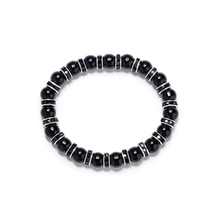 Beaded black onyx bracelet with silver rhinestone spacers on a clean white background
