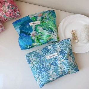 Detailed close-up of floral liberty print cotton makeup bags with simple wish woven labels