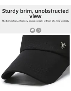 Close-up of the long brim on a black mesh baseball cap with metal shield logo detail
