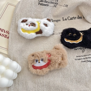 Detail of cute fluffy plush pins with cartoon embroidery on beige canvas fabric