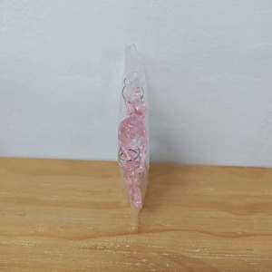 Detailed view of pink acrylic snowflake ornaments packed in a transparent poly bag