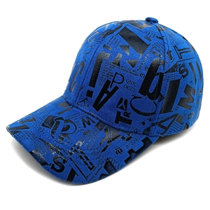 Close-up of graffiti lettering on a bright blue cotton baseball cap with fabric texture