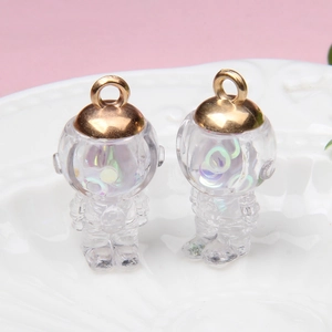 Macro view of transparent astronaut pendants with colorful sequins and golden rings