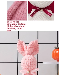 Detail of bunny-shaped coral fleece towels with pineapple grid texture and pearl ribbon