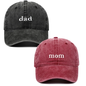 Detail of embroidered dad and mom text on washed cotton baseball caps in black and burgundy