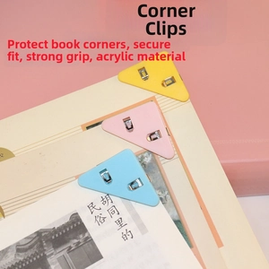 Detail of colorful acrylic triangle corner clips holding paper edges in yellow and pink