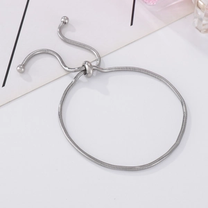 Detailed view of the adjustable silver snake chain bracelet with round sliding buckle