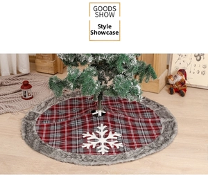 Detail of red and grey plaid Christmas tree skirt with white snowflake and faux fur edge