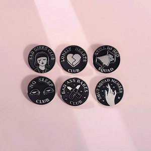 Set of six black enamel lapel pins with geometric flame and slogans on pink background