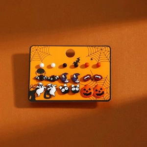 Close-up of Halloween earring set featuring enamel ghost, pumpkin, and bat designs