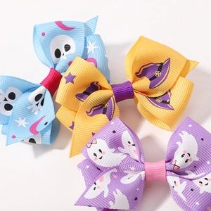 Set of 3 Halloween bow hair clips with skull, ghost, and witch hat patterns on white background