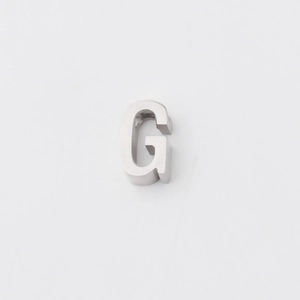 Detailed view of a mirror-polished stainless steel letter G pendant with a small hole
