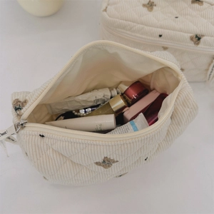 Detail of bear pattern corduroy pouch with diamond quilting and large capacity interior