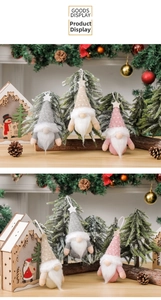 Close-up of three knitted Christmas gnomes with stars on hats and hanging loops