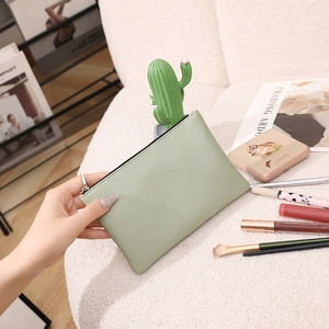 Litchi pattern PU leather slim cosmetic bag in light green with a secure zipper closure