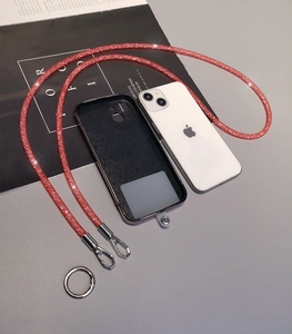 Detail of red glitter phone lanyard with black honeycomb case and silver metal ring