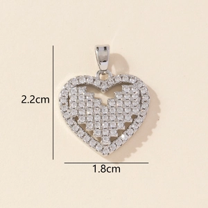 Macro shot of silver pixel heart pendant showing 2.2cm height and 1.8cm width details